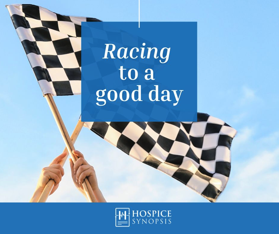 Two checkered racing flags beneath the words ‘Racing to a Good Day.’