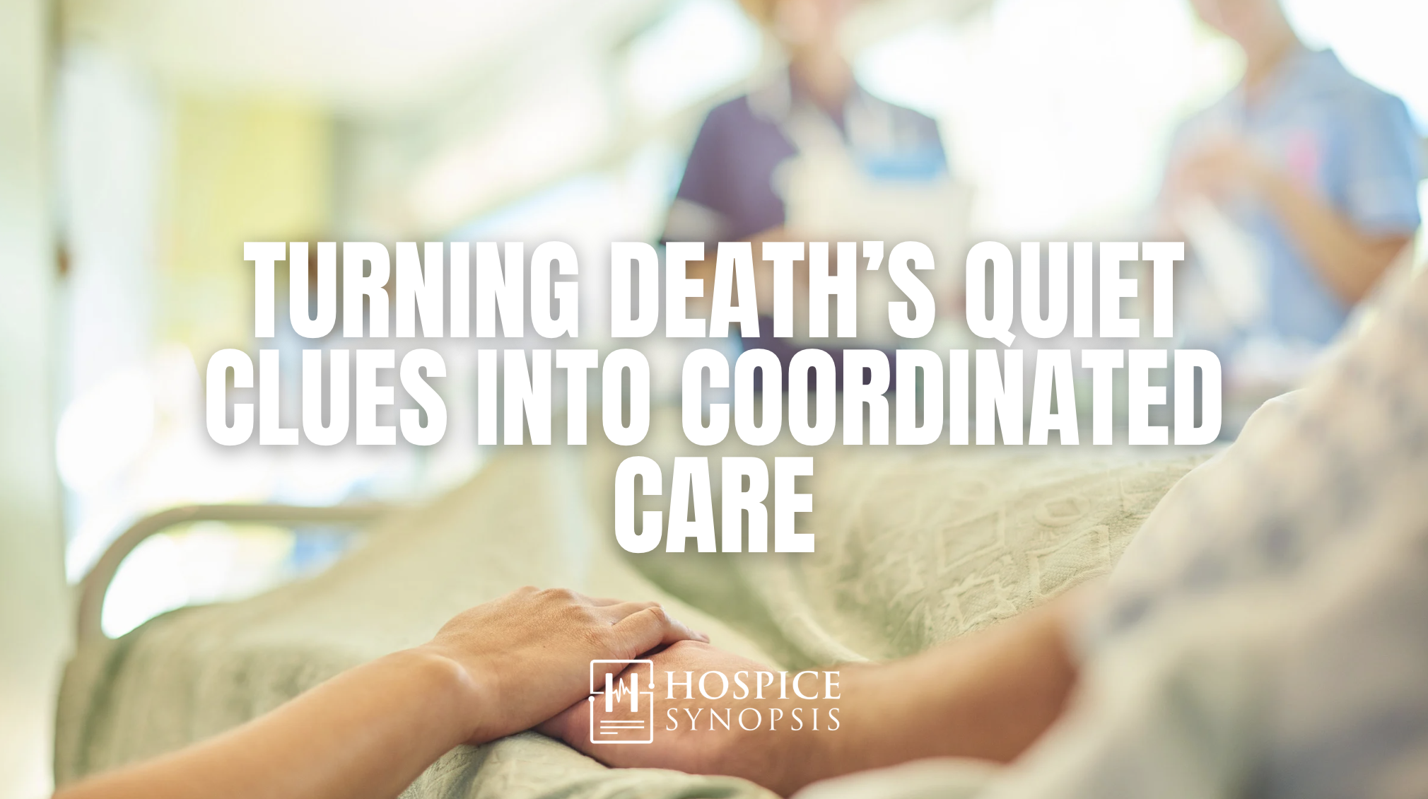 A clinician holds a patient’s hand while a hospice team gathers in the background.